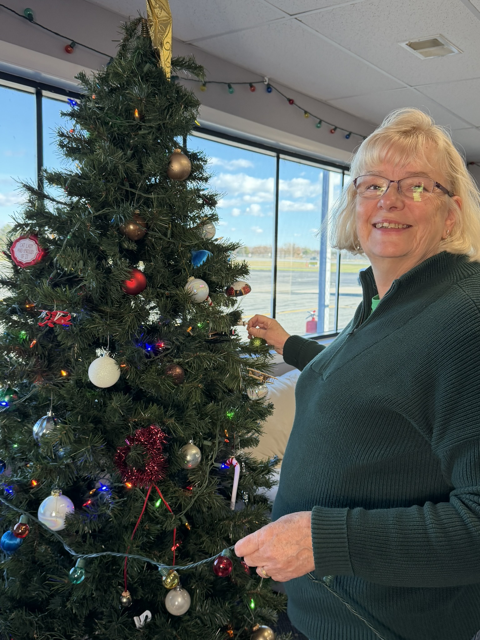 flight school pilot sets up Christmas tree